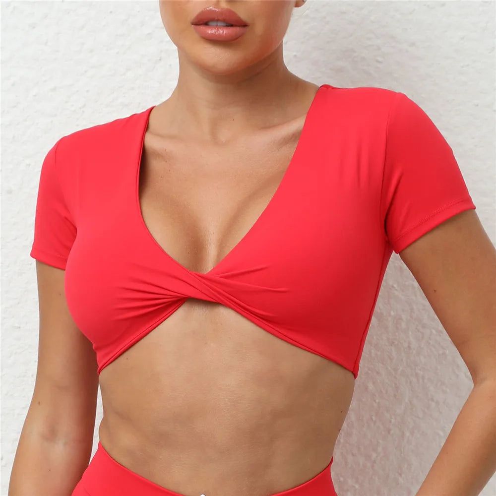 2025 Women's padded short sleeve crop yoga top in vibrant red, perfect for workouts and stylish comfort.