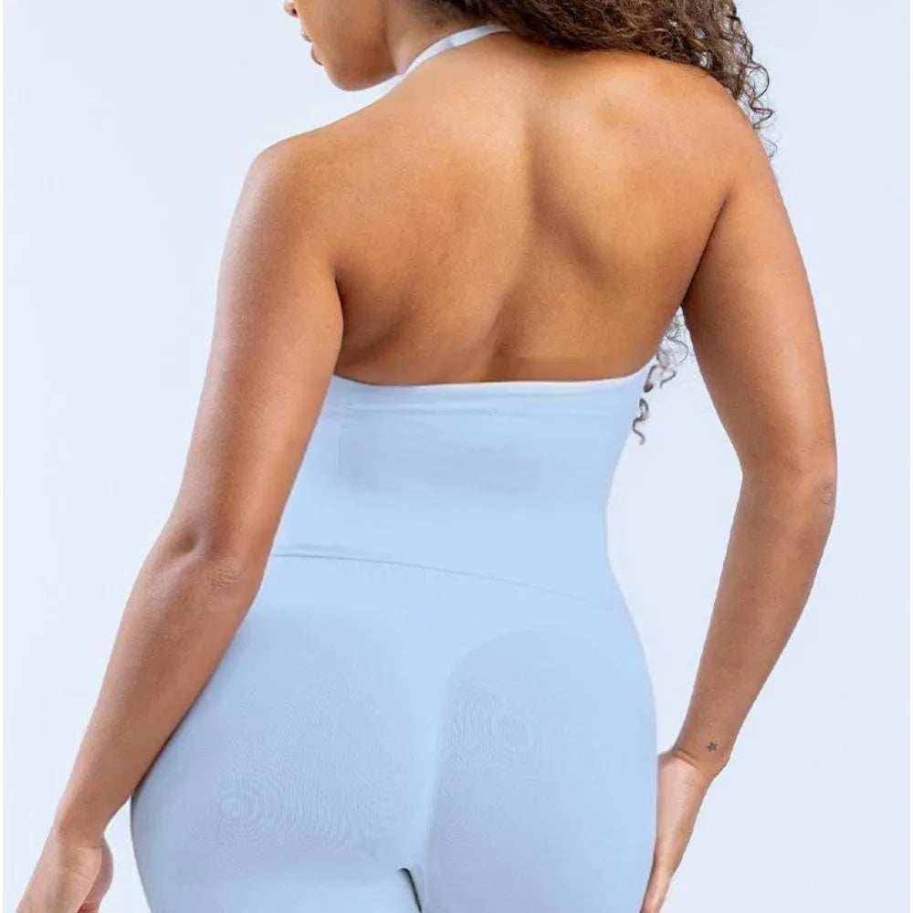 Back view of a woman wearing a light blue strappy V-neck yoga fitness vest, showcasing its open-back design.