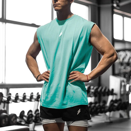 Model wearing a turquoise summer fitness sports tank top in a gym setting, showcasing breathability for workouts.