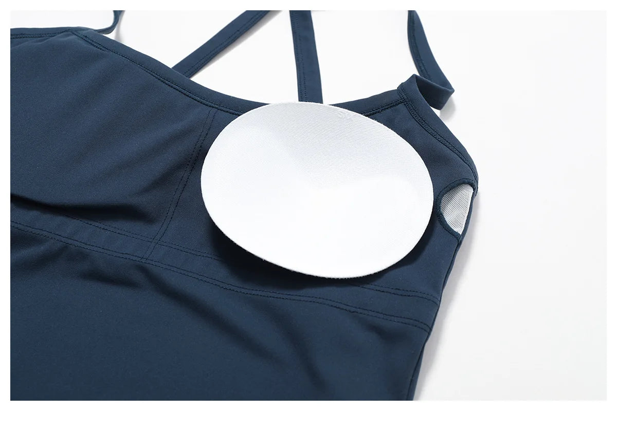 Close-up of a navy blue Cross Back Push-Up Sports Bra showing removable padding and wide strap design.