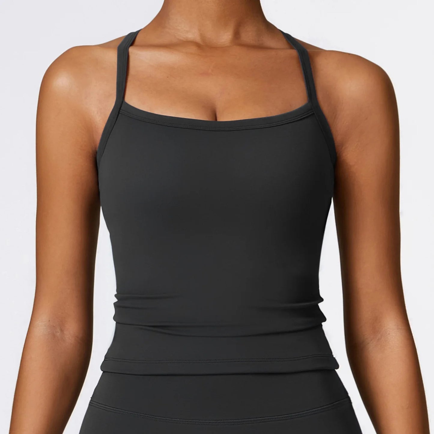Black cross-back push-up sports bra with wide straps for optimal support and breathable fit.