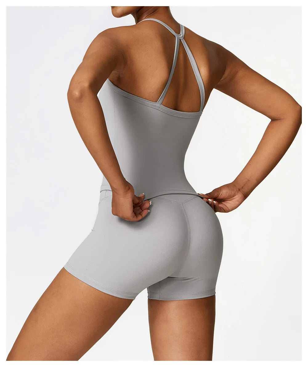 Woman wearing a cross back push-up sports bra and shorts, showcasing a stylish and supportive workout outfit.