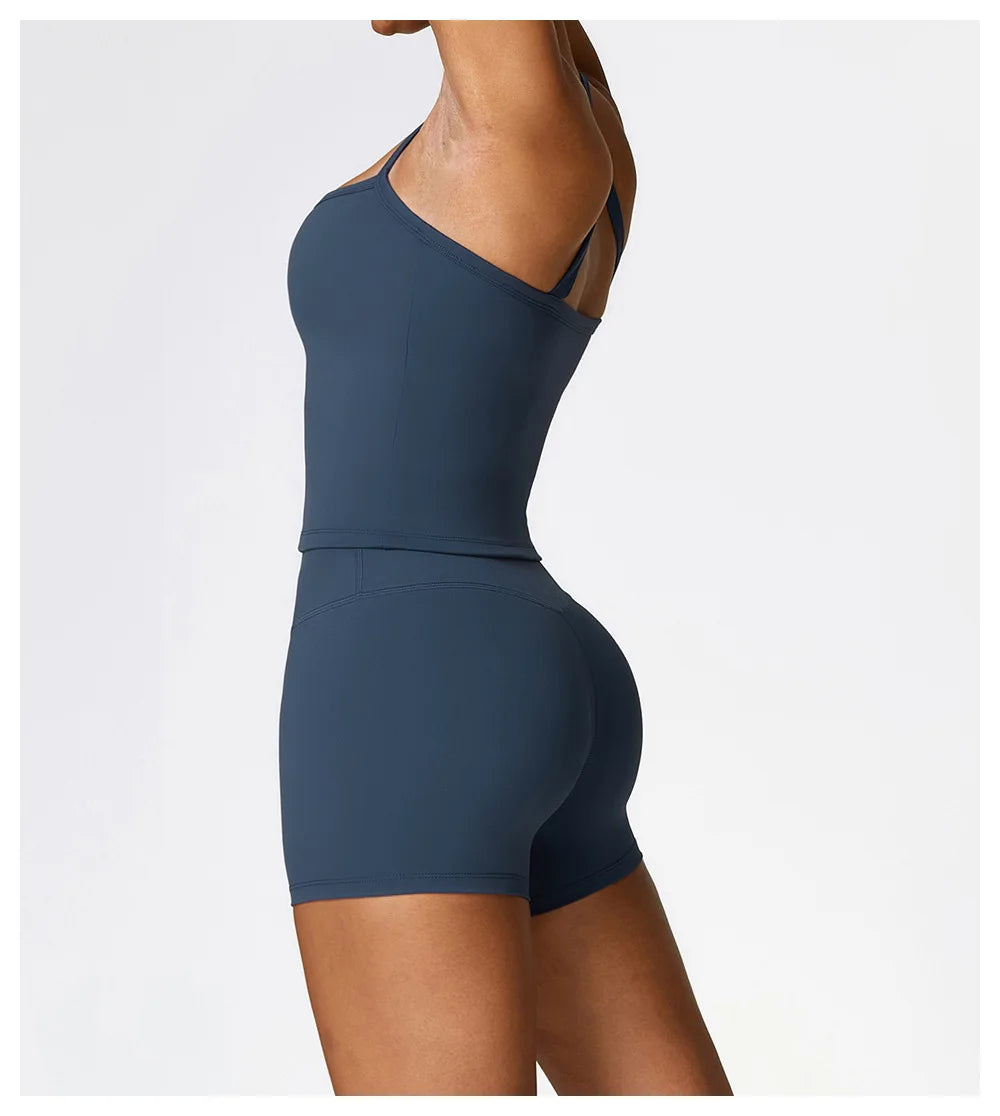 Side view of a woman wearing a blue athletic outfit, showcasing a fitted top and shorts for sports training.