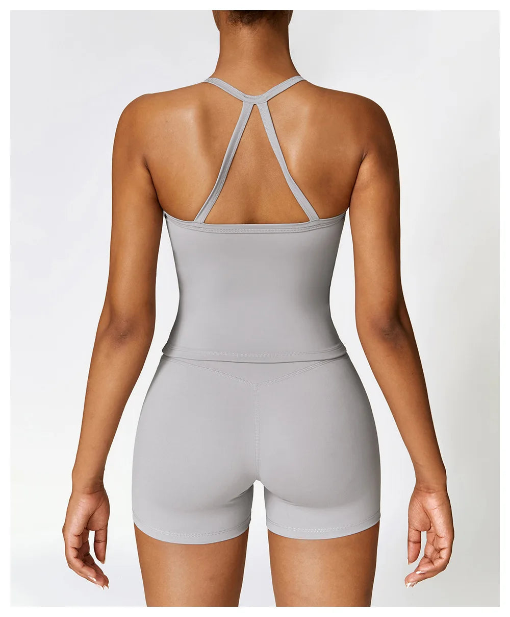 Back view of a woman wearing a gray Cross Back Push-Up Sports Bra with wide straps and a fitted design.