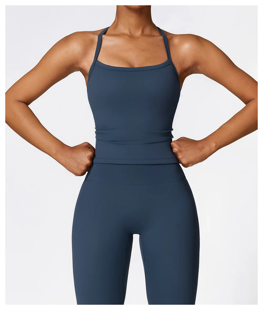 Model wearing a dark blue Cross Back Push-Up Sports Bra with wide straps, showcasing support and style.