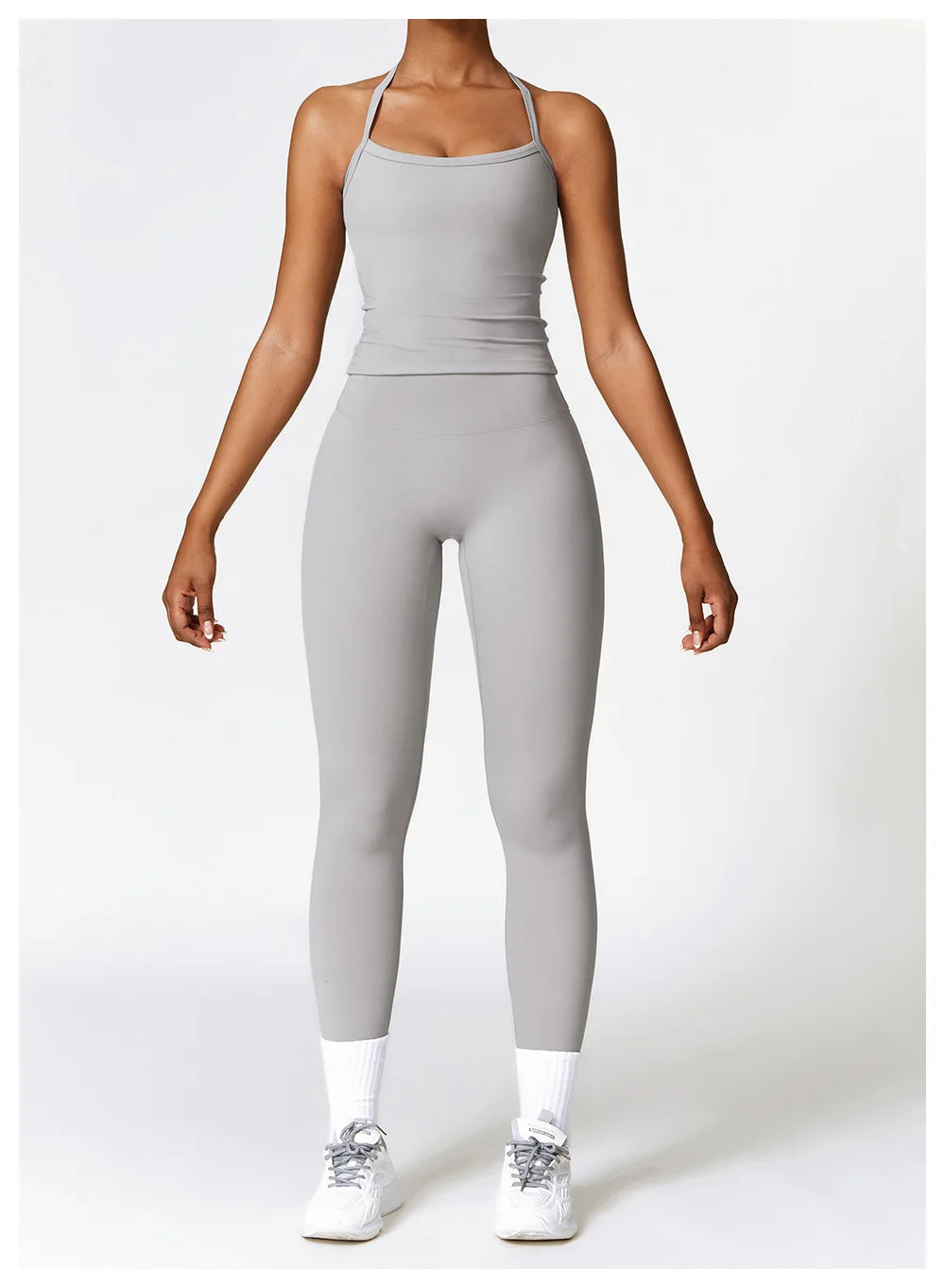 Woman in grey sports bra and leggings showcasing athletic wear for stylish workouts and comfort.