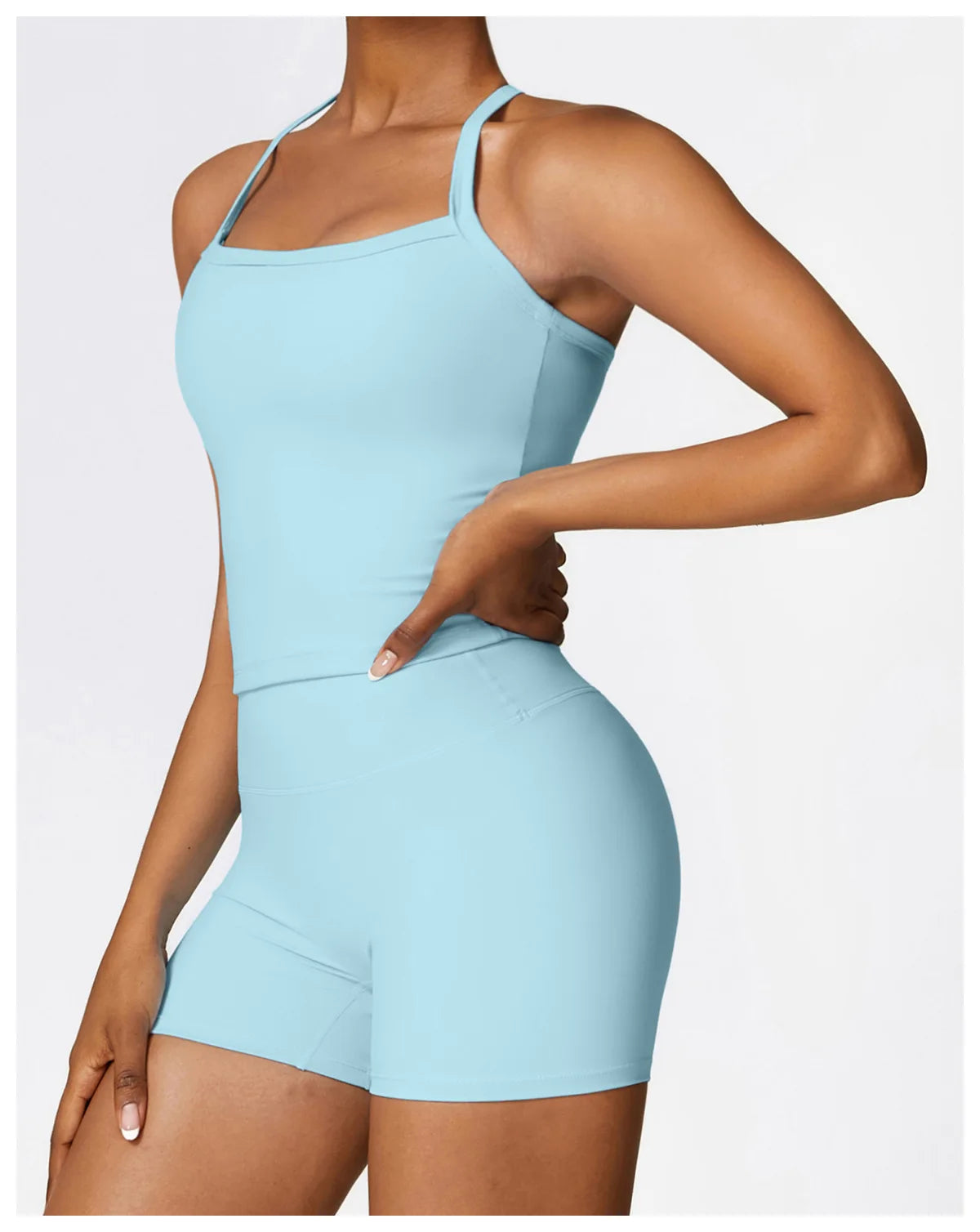 Model wearing a light blue sports bra and shorts, showcasing a stylish and comfortable workout outfit.