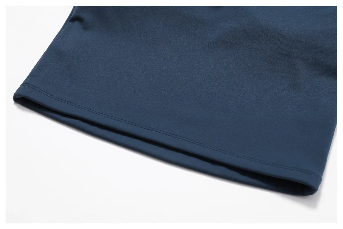 Close-up of the hem of a navy sports bra showcasing its smooth, moisture-wicking fabric and stitching detail.