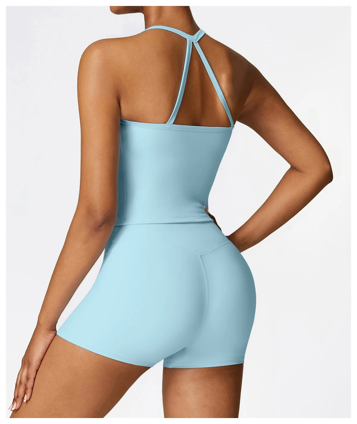 Back view of a woman wearing a light blue Cross Back Push-Up Sports Bra with matching shorts.