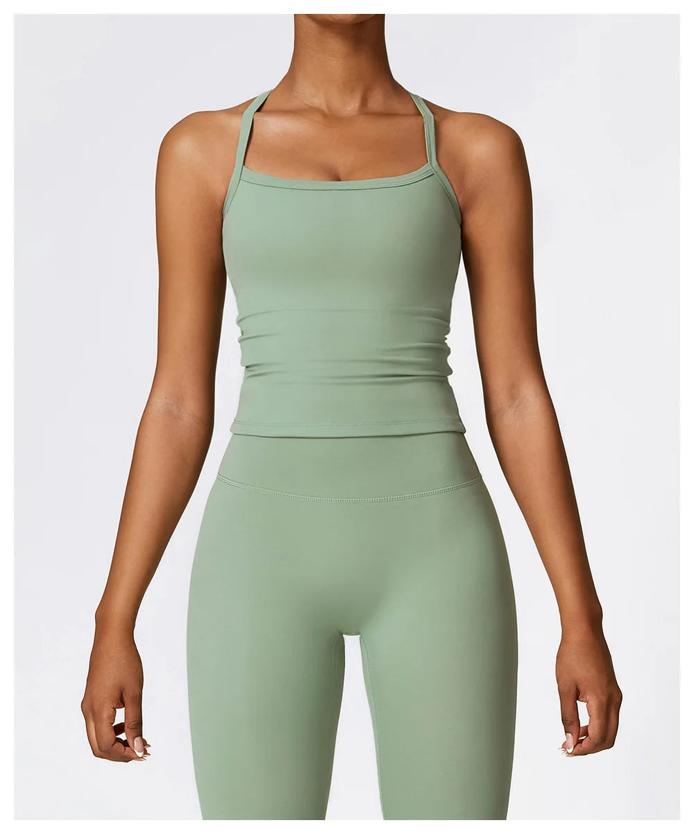Green cross back push-up sports bra with wide straps and matching leggings, perfect for high-impact workouts.