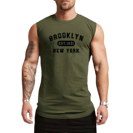Man wearing a sleeveless olive green tank top with Brooklyn New York graphic, perfect for summer workouts.