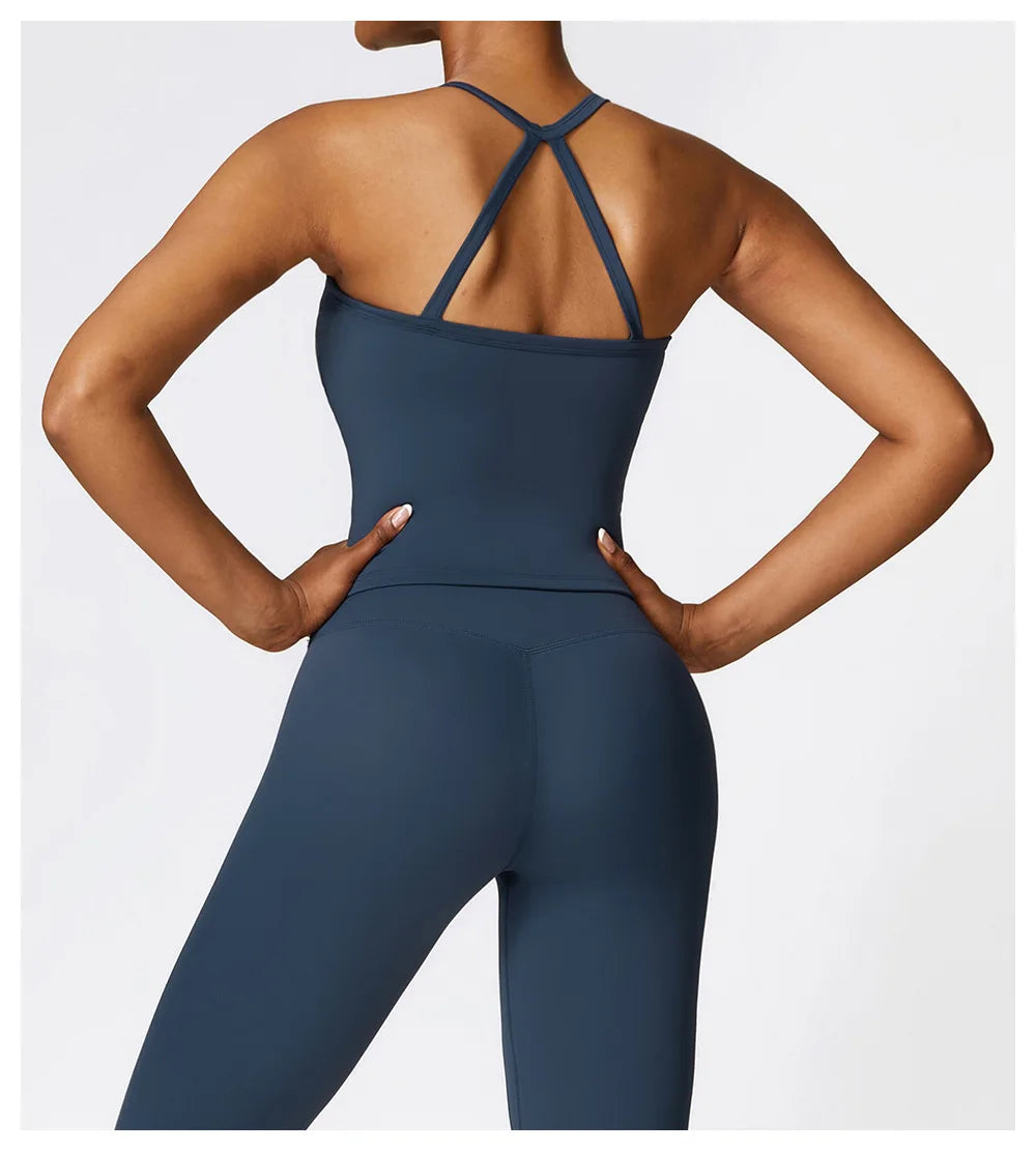 Back view of a woman wearing a cross back push-up sports bra and leggings, showcasing stylish and supportive activewear.