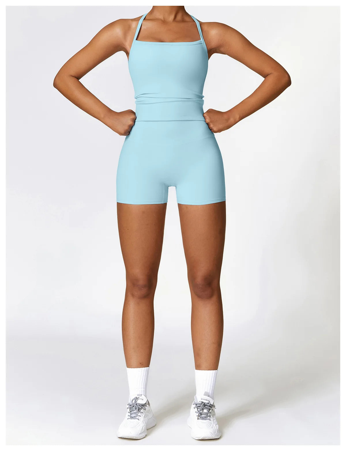 Model wearing a light blue sports outfit, showcasing high-performance activewear for fitness activities.