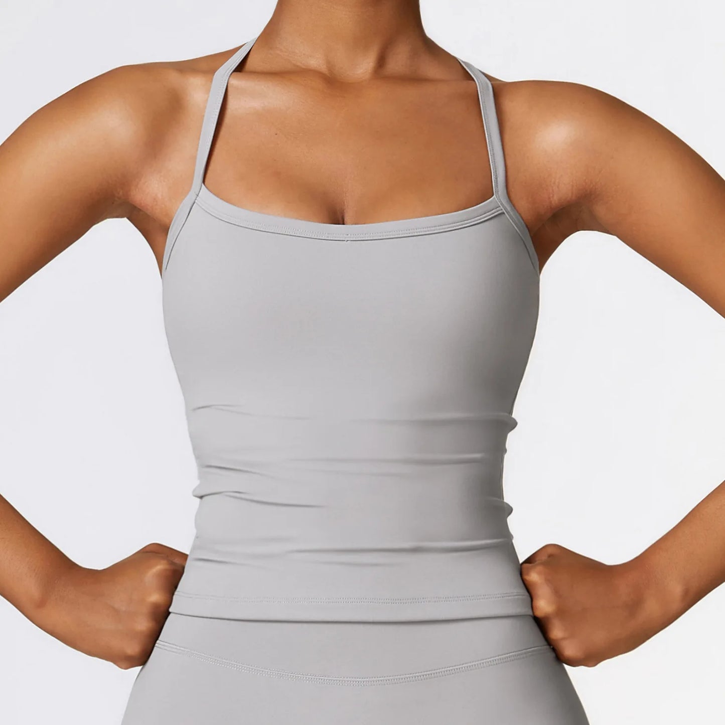 Gray cross back push-up sports bra for women, designed for high-impact support and stylish performance.