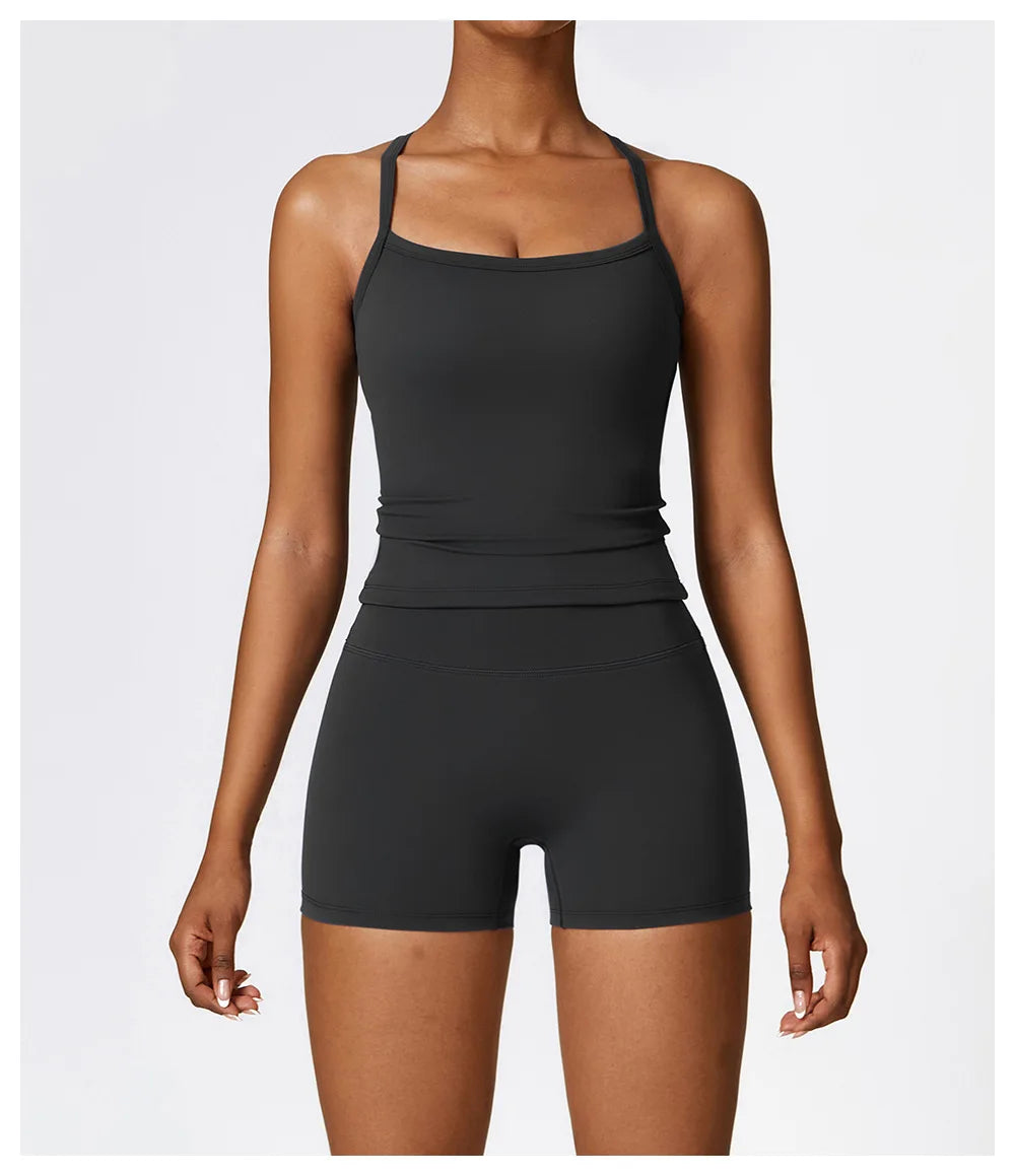 Women's black sports outfit featuring a fitted tank top and matching shorts, ideal for workouts and activewear.